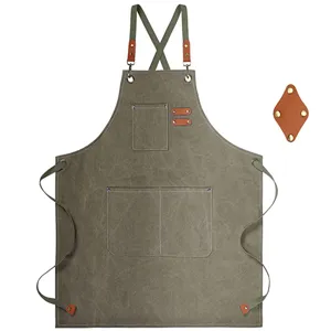 Detailed view of heavy-duty canvas apron with cross straps, leather patches and multiple pockets.