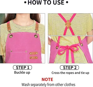 Detail showing how to wear the pink canvas work apron with cross back straps and metal buckles.