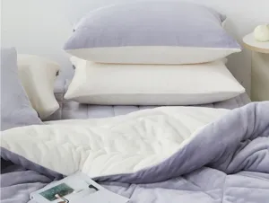 Detailed view of the cozy color-blocking flannel bedding set and soft pillows in purple and white.