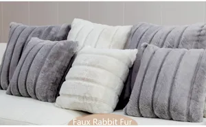 Soft faux rabbit fur cushion detail showcasing plush striped texture on a cozy white sofa.