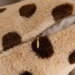 Close-up detail of soft faux fur polka dot cushion cover with zipper closure, cozy texture.