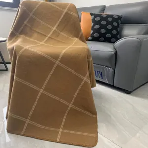 Cozy brown plaid knitted blanket, soft double-sided throw for sofa, bed, and office use.