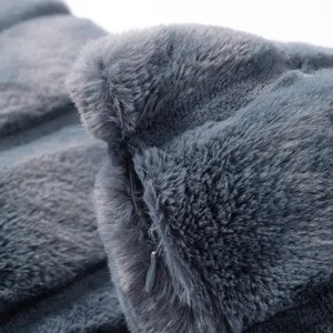 Close-up detail of soft dark gray faux rabbit fur throw pillow cover, showing plush texture and zipper.