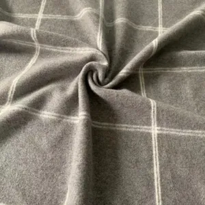 Detailed view of soft grey plaid wool blend blanket fabric showing rich texture and fine weave.