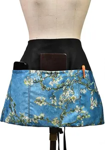 Detailed view of the multi-pocket waist apron featuring a vibrant floral art print.