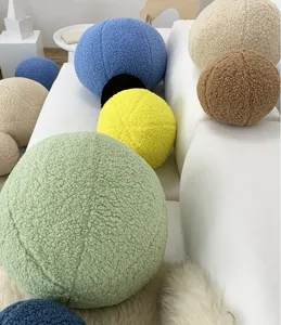 Nordic minimalist teddy fleece round ball throw pillow detail scene on white sofa.