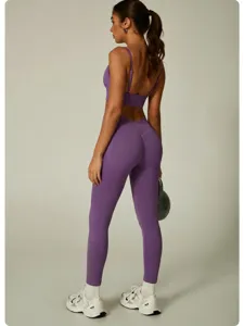 Seamless purple activewear yoga set detail view, high waist fitness leggings and sports bra.