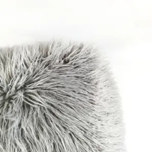 Grey shaggy faux fur pouffe detail close-up showing soft fluffy long plush cushion texture