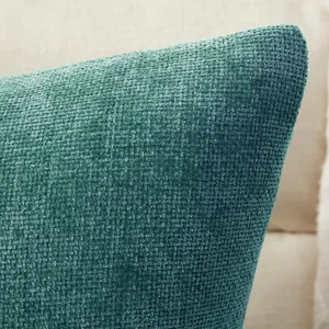 Close-up view of teal green chenille cushion cover showcasing soft textured woven fabric detail.