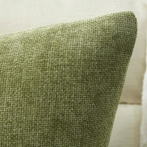 Close-up detail of green chenille throw pillow fabric showing soft textured woven grid pattern.