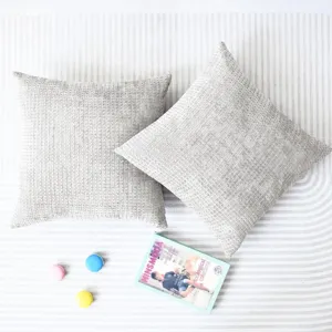 Detailed view of grey waffle chenille throw pillow cover, soft textured fabric on striped background.