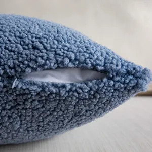 Close-up detail view of soft blue teddy fleece pillow cover showing neat zipper and texture.