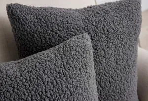 Dark grey sherpa throw pillow cover detail shot, soft plush texture close up view.