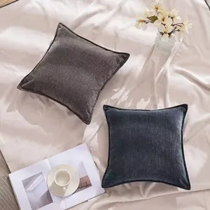 Detail view of textured throw pillows on bed, showcasing cozy home decor and soft fabric.