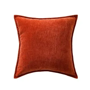 Close-up detail of the textured chenille throw pillow fabric, showing fine rust red weave.