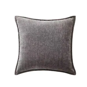 Close-up of dark grey chenille throw pillow fabric texture and fine stitched edge detail.