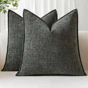 Detail of dark grey textured chenille throw pillow with flange edge for sofa and bed decor.