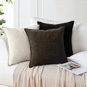 Detailed view of thick chenille throw pillows on a cozy white sofa, ideal for modern home decor.