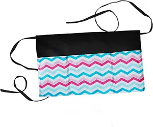 Close-up detail of the multi-pocket waist apron featuring chevron pattern and black ties.