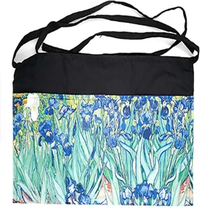 Half-length waist apron with blue iris floral print and black pockets for daily kitchen work.