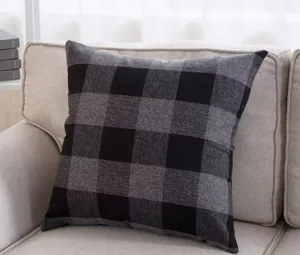 Detail view of a black and gray buffalo plaid throw pillow, soft cotton linen cushion cover.