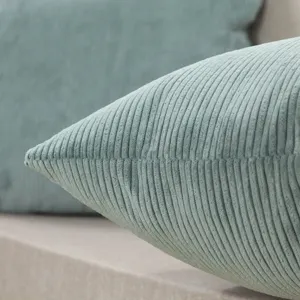 Fine corduroy throw pillow closeup showing soft mint green texture for modern living room sofa.