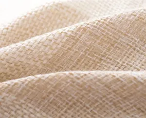 Close-up detail of soft natural cotton linen fabric texture, breathable and durable material.