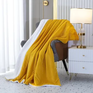 Soft double-sided solid color flannel fleece sofa blanket, cozy bedroom decor detail.