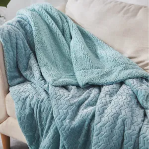 Soft blue flannel throw blanket detail, cozy cable knit texture for home sofa and office use.