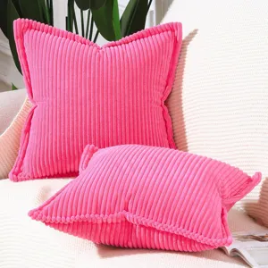 Close up view of vibrant pink corduroy pillow covers featuring stylish textured stripes detail.