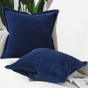 Close up of deep blue corduroy striped pillow cover detail, modern minimalist sofa cushion.