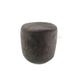 Dark grey plush round ottoman detail, soft furry floor pouf texture close-up view.