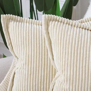 Close up detail of modern cream corduroy striped cushion cover with textured flanged edge.