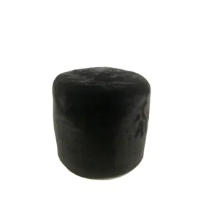 Black velvet round footstool detail shot, minimalist pouf ottoman for cozy living room decor.