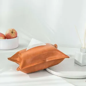 Detail shot of brown oil-wax leather tissue box cover, soft texture for home decor.