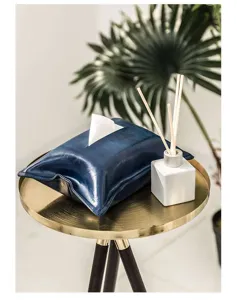 Close-up of blue faux leather tissue box cover, soft texture detail for home decor.