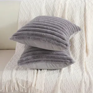 Grey faux rabbit fur striped throw pillow, soft cushion for sofa and bedroom decor.