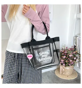 Clear PVC tote bag for women, stylish large capacity waterproof shoulder handbag with print.
