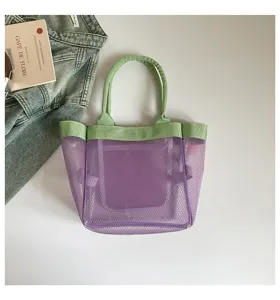 Close-up of purple mesh tote bag with green handles and trim, casual style detail view.