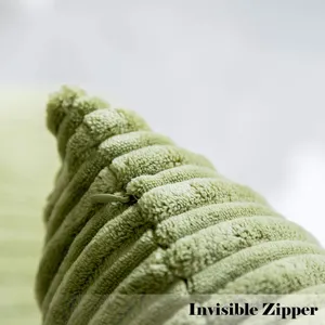 Corduroy pillow cover detail showing invisible zipper in light green, soft textured fabric.
