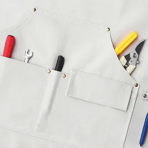 Canvas apron detail showing durable pockets, stitching, and tool storage for work.