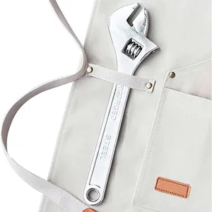 Heavy duty canvas work apron detail featuring tool pocket and adjustable steel wrench.