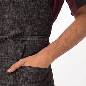 Close-up view of the dark textured cotton linen apron pocket and waist tie details.