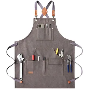 Canvas work apron detail showing multi-pocket tool storage and durable hardware.