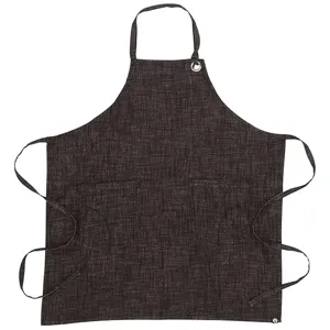 Close-up detail of dark grey cotton linen apron featuring dual front pockets and secure neck strap.