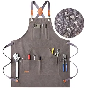 Heavy duty canvas apron with multiple tool pockets and cross back straps for BBQ cooking.