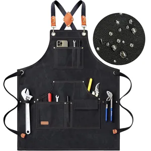 Heavy duty waxed canvas work apron with cross back leather straps and multiple tool pockets.
