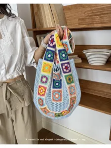 Handcrafted crochet tote bag detail, featuring colorful floral squares and light blue knit.