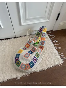 Detailed view of the colorful crochet shoulder bag in a cozy indoor lifestyle setting.