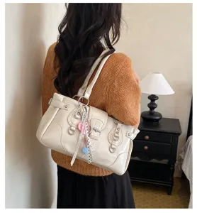 Vintage shoulder bag for women, retro tote bag with metal buckles and stylish handbag design.